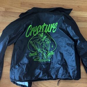 Creature Black Windbreaker Jacket with Neon Green Graphic